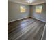 This bedroom features hardwood floors, neutral paint, and has plenty of natural light at 12801 College Hill Dr, Hudson, FL 34667