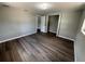 Bedroom with hardwood floors, closet, and a window with natural light at 12801 College Hill Dr, Hudson, FL 34667