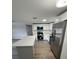 Well-equipped kitchen featuring new stainless steel appliances and a center island at 12801 College Hill Dr, Hudson, FL 34667