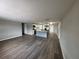 Spacious living room flows into kitchen featuring updated cabinets and new stainless steel appliances at 12801 College Hill Dr, Hudson, FL 34667
