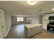 Open floor plan with kitchen island, updated appliances, and hardwood flooring at 12801 College Hill Dr, Hudson, FL 34667