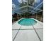 Enjoy a refreshing swim in this screened in outdoor pool, perfect for hot summer days at 12801 College Hill Dr, Hudson, FL 34667