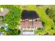 Aerial view of property showcasing proximity to nearby lake and community pool at 13512 Palmwood Ln # 13512, Tampa, FL 33618