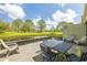 Relaxing backyard patio with views of a tranquil pond and lush green landscape at 13512 Palmwood Ln # 13512, Tampa, FL 33618