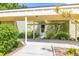 Inviting covered entrance with lush landscaping and a well-maintained walkway leading to the front door at 13512 Palmwood Ln # 13512, Tampa, FL 33618