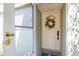 Charming front door with wreath, sidelight, and screen door, offering a warm welcome at 13512 Palmwood Ln # 13512, Tampa, FL 33618