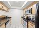 Functional kitchen featuring stainless steel appliances, ample cabinet space, and tiled floors at 13512 Palmwood Ln # 13512, Tampa, FL 33618