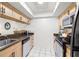 Functional kitchen with stainless steel appliances, light cabinetry, dark countertops, and a mirrored backsplash at 13512 Palmwood Ln # 13512, Tampa, FL 33618