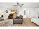 Bright living room featuring wood floors, ceiling fan, and comfortable seating near the partial kitchen at 13512 Palmwood Ln # 13512, Tampa, FL 33618