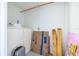 Image of a storage area with shelving, boxes, wood planks, and colorful artwork leaning against a wall at 13512 Palmwood Ln # 13512, Tampa, FL 33618