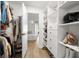 Spacious walk-in closet boasting custom shelving, drawers, and ample storage space for clothes and shoes at 13512 Palmwood Ln # 13512, Tampa, FL 33618