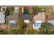 Aerial view showcasing the property with neighboring homes, pools, and surrounding greenery at 14199 82Nd Avenue, Seminole, FL 33776