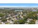 An aerial view displays the neighborhood, the water and bridges beyond, and a lovely community at 14199 82Nd Avenue, Seminole, FL 33776