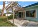 Outdoor patio with a pergola, pavers, and access to the backyard and the house at 14199 82Nd Avenue, Seminole, FL 33776