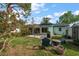 Charming backyard features a stone patio, well maintained lawn and space for outdoor entertaining at 14199 82Nd Avenue, Seminole, FL 33776