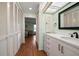 A serene bathroom with a pristine white vanity, plenty of storage, and light green walls at 14199 82Nd Avenue, Seminole, FL 33776