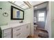 Well-lit bathroom with a modern vanity and a view into the shower room at 14199 82Nd Avenue, Seminole, FL 33776