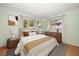 Well-lit bedroom featuring neutral decor, bedside tables, and windows with curtains at 14199 82Nd Avenue, Seminole, FL 33776