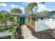 Inviting front entrance with double doors, decorative plants, and a covered walkway with string lights at 14199 82Nd Avenue, Seminole, FL 33776