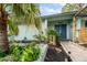 Well-maintained front yard landscaping with lush plants, decorative elements, and a charming garden bed at 14199 82Nd Avenue, Seminole, FL 33776