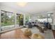 Cozy living room with a large sectional couch, a decorative rug, and access to the backyard at 14199 82Nd Avenue, Seminole, FL 33776