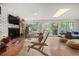 Inviting living room with a brick fireplace, comfortable seating, and access to the backyard at 14199 82Nd Avenue, Seminole, FL 33776