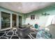 Inviting outdoor patio with a covered seating area, potted plants, and sliding glass doors for easy indoor-outdoor living at 14199 82Nd Avenue, Seminole, FL 33776