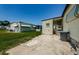 A view of the home's backyard, showing well-maintained landscaping and an open patio area at 144 Melody Ln, Tarpon Springs, FL 34689