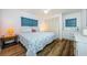Bedroom features wood-look floors, ample closet space, and a double bed with a colorful quilt at 144 Melody Ln, Tarpon Springs, FL 34689