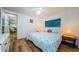 Cozy bedroom with wood-look floors, ensuite access, and natural lighting at 144 Melody Ln, Tarpon Springs, FL 34689