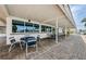 Inviting patio area with tables and chairs, providing a comfortable outdoor gathering space for residents at 144 Melody Ln, Tarpon Springs, FL 34689