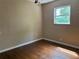 Simple bedroom with hardwood floors, natural light from a window, and space for a cozy retreat at 1902 W Aileen St, Tampa, FL 33607