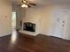 Cozy living room with hardwood floors and a painted brick fireplace that creates a warm, inviting space at 1902 W Aileen St, Tampa, FL 33607