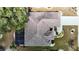 Overhead view of a house with a tile roof, screened-in lanai, landscaping, and a manicured lawn at 2018 E Del Webb Blvd, Sun City Center, FL 33573