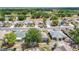 Aerial view of a neighborhood showcasing well-maintained homes, mature trees, and scenic surroundings at 2018 E Del Webb Blvd, Sun City Center, FL 33573