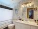 A bathroom featuring an updated countertop and stylish polka dot shower curtain at 2018 E Del Webb Blvd, Sun City Center, FL 33573
