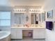 Bright primary bathroom with double sink vanity, corner soaking tub, and separate shower at 2018 E Del Webb Blvd, Sun City Center, FL 33573