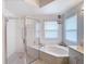 Well-lit ensuite bathroom featuring corner soaking tub and glass shower at 2018 E Del Webb Blvd, Sun City Center, FL 33573
