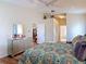 Bright bedroom featuring wood floors, ceiling fan, walk-in closet and ensuite bathroom at 2018 E Del Webb Blvd, Sun City Center, FL 33573