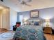 Well decorated primary bedroom featuring wood floors, ceiling fan, recliner, and painting at 2018 E Del Webb Blvd, Sun City Center, FL 33573