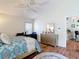 Vaulted ceiling bedroom featuring wood floors, ceiling fan, and an ensuite bathroom at 2018 E Del Webb Blvd, Sun City Center, FL 33573