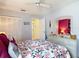 A tranquil bedroom featuring a floral comforter and ample closet space at 2018 E Del Webb Blvd, Sun City Center, FL 33573