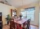Bright dining room featuring a decorative chandelier, wood-look flooring, and a lovely table setting at 2018 E Del Webb Blvd, Sun City Center, FL 33573
