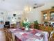 Spacious dining room with decorative chandelier, table, and chairs in a well-lit setting at 2018 E Del Webb Blvd, Sun City Center, FL 33573