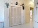 Hallway with tile floor, multiple storage closets, and view of another room at 2018 E Del Webb Blvd, Sun City Center, FL 33573