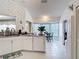 Efficient kitchen space connecting to the dining area, featuring bright white cabinets and modern appliances at 2018 E Del Webb Blvd, Sun City Center, FL 33573