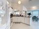 Bright kitchen features white cabinets, granite countertops, and stainless steel appliances at 2018 E Del Webb Blvd, Sun City Center, FL 33573
