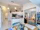 Open-concept kitchen with white appliances and adjacent living space, perfect for modern living and entertaining at 2018 E Del Webb Blvd, Sun City Center, FL 33573