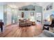 Inviting living room featuring comfortable recliners, wood-look floors, and a view towards the bedroom at 2018 E Del Webb Blvd, Sun City Center, FL 33573