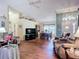 Open-concept living area with vaulted ceilings, wood-look floors, and dining area with great natural light at 2018 E Del Webb Blvd, Sun City Center, FL 33573